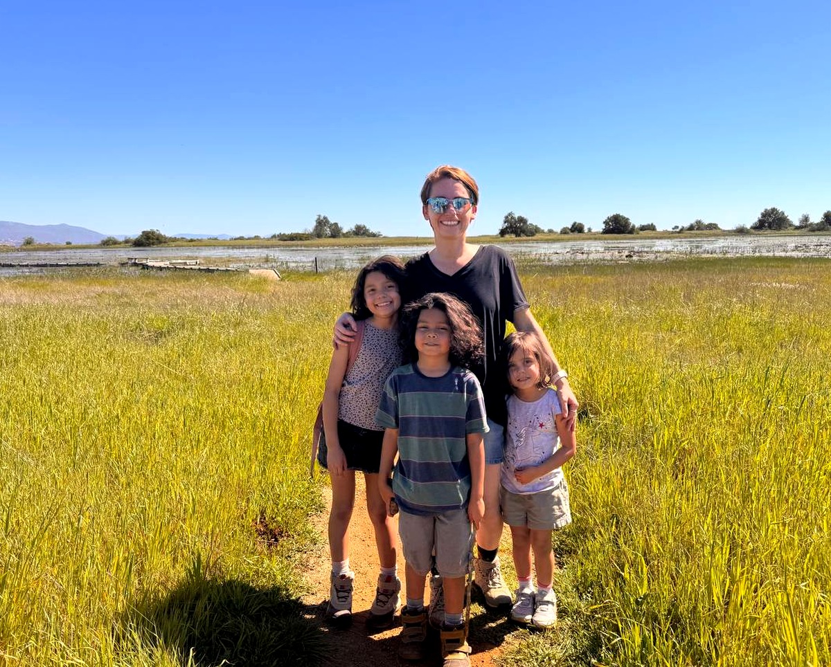 Scarlette with her children outdoors